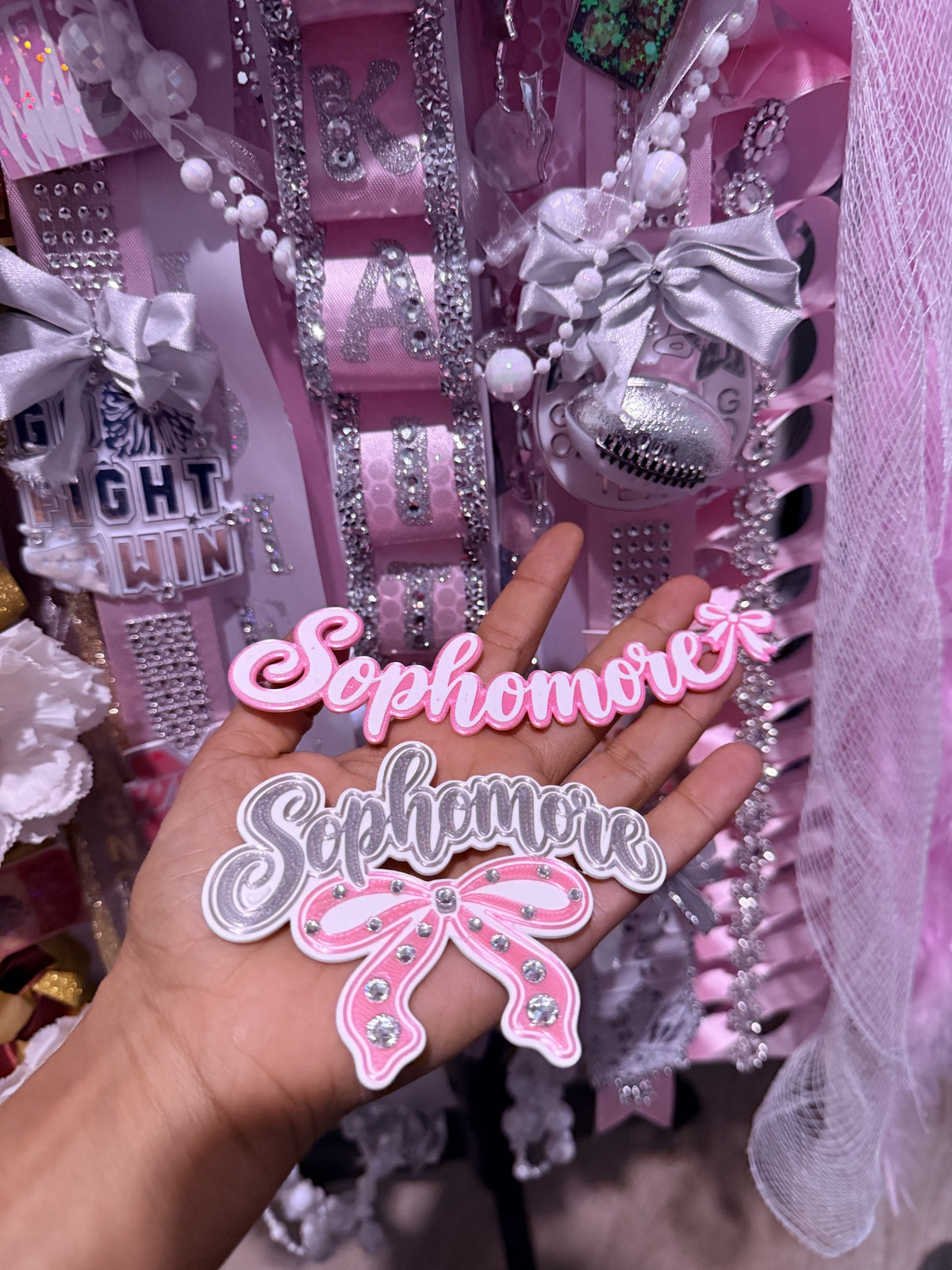 Custom pink and silver Sophomore homecoming mum trinkets, including rhinestone bow