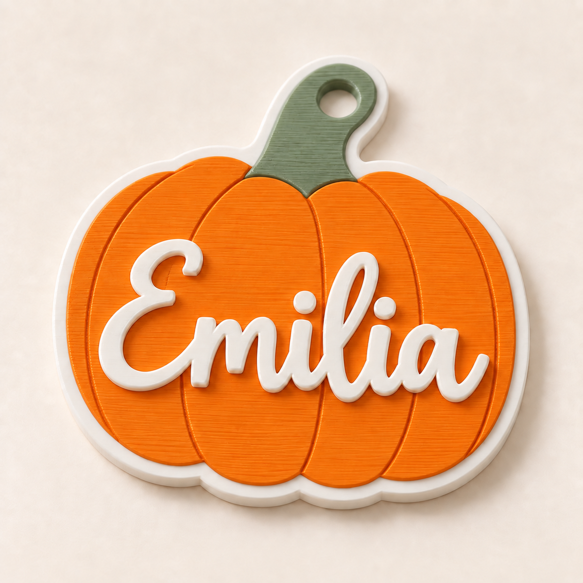 Orange personalized 3D printed pumpkin name tag with white lettering and green stem